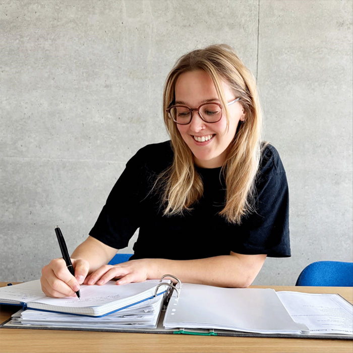 employee-in-blue-shirt-before-office-backdrop
